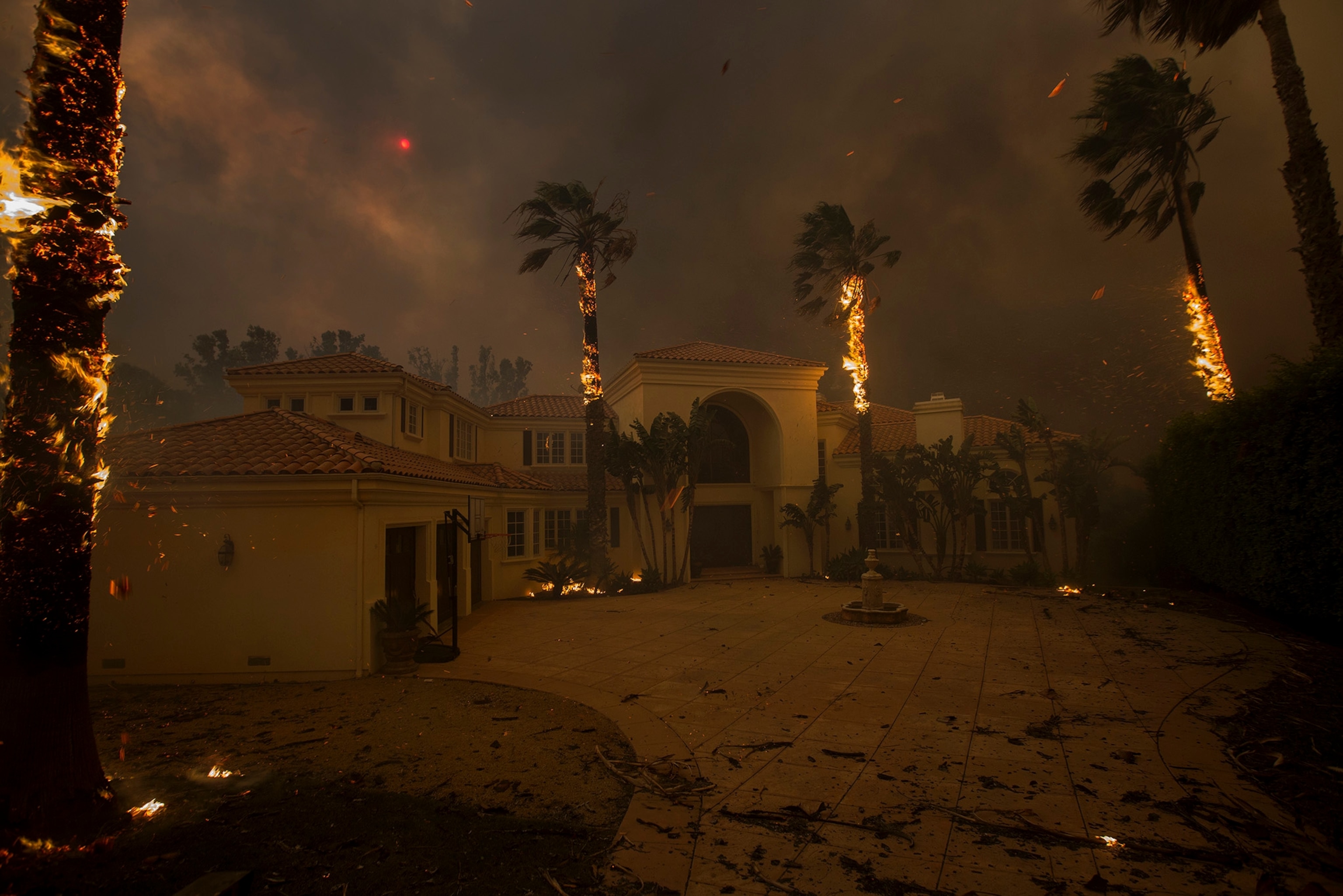 a house with burning palms