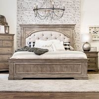 The rustic and tufted look on this traditional panel bed pairs perfectly with your farmhouse or French country-inspired home. It features a button-tufted headboard that's upholstered in polyester and stuffed with foam to give you a cushioned place to kick back and relax. Nailhead trim lines the headboard for a glam look, and crown top molding tops it off. The frame is made from a blend of solid and engineered wood in a natural wood grain finish, and the footboard is accented with detailed moldin