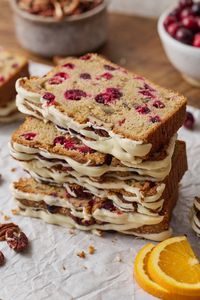 This festive cranberry orange bread recipe combines fresh orange juice, orange zest, cranberries, and crunchy pecans! We love this topped with a sweet orange glaze, but a dusting of powdered sugar is also a delicious option. Fresh or frozen cranberries both work great!