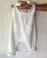 Pretty white boho baby romper in soft cotton or linen.