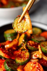 My Quick Korean Cucumber Kimchi combines sliced cucumber with carrots, onion, garlic and chili and can be prepared in only 30 minutes. These crisp and refreshing vegetables are the perfect balance of sweet, sour, salt and spice that you come to expect from a good Cucumber Kimchi recipe.  // acedarspoon.com