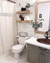 This beautiful bathroom actually has DIY sharpie shiplap! That's right, this isn't actually shiplap... it's drawn on with sharpie. Sierra Joseph is a master at doing renovations on a budget. The floors, countertop, and cabinets were also a DIY makeover that transformed this little guest bathroom into an eclectic farmhouse spa-getaway. Photo by @withlovesierra. #farmhousebathroom #rusticfarmhouse #modernfarmhouse #diy #interiordesign