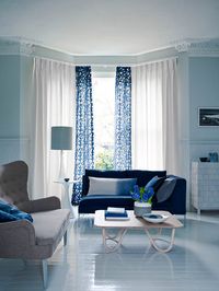 Creative touches such as panels and contrasting colour or pattern make simple window treatments stand out from the everyday. Applying a border to plain curtains is a good way of introducing pattern to a room. This blue and white fabric cleverly pulls together the colours of the scheme. Homes & Gardens, Curtain Call, Finishing Touches, March 2014, Photography Jake Curtis, Styling Lorraine Dawkins