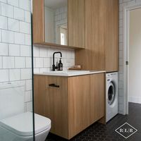 Red Lily Renovations Bathroom - Perth. Essa Stone Verona bench top. Elegant Oak laminex doors. Roca Gap Toilet Suite from Reece. Ultra white gloss wall tile in brick bond pattern. Frameless shower panel. Black mosaic hexagonal floor tiles.