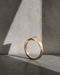 Available in two unisex sizes, the 18k rose gold Vashi signet ring is shaped to a unique peaked silhouette, with clean-lined angles creating a distinctly modern and utilitarian mood. You can keep it simple or choose a personalised engraving like a special message, your own handwriting, or fingerprint, email the team here to discuss what you'd like.