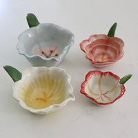 Add a touch of floral fun to your kitchen with these Pretty Posies Pinch Bowls. These playful bowls are perfect for holding spices, condiments, or even jewelry! Grab a set and add some quirk to your cooking routine. Measures: 6-3/4"L x 4-3/4"W x 3-1/4"H, 6"L x 4-1/2"W x 2"H, 5"L x 4"W x 1-1/2"H & 4"L x 3-1/4"W x 1"H Hand-Painted Stoneware Flower Shaped Prep Bowls Multi Color, Set of 4 Food Safe Material: Stoneware