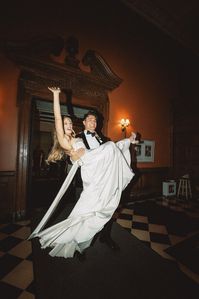 Josh carrying his bride out of their wedding at the Greystone Mansion in Beverly Hills, CA. Direct flash reception photography of bride and groom. Save this post for your wedding reception inspo