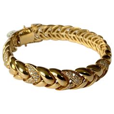 By Swiss designer Gübelin, this 18 K yellow Gold bracelet with a classic and timeless design is set with 182 brilliant cut Diamonds weighing approximately 2 ct, G color, vs clarity. The length is 19 cm the width is 1.2 cm and the bracelet weighs 63.17 grams. This is a great bracelet for everyday wear. Masterfully handcrafted piece! Authenticity and money back is guaranteed. For any enquires, please contact the seller through the message center. Luxury 22k Gold Yellow Bracelet, Luxury Yellow Gold Symbolic Bracelets, Luxury Vintage Gold Bracelet As A Gift, Luxury Yellow Gold Bracelet With Intricate Design, Luxury Vintage Gold Bracelets, Luxury Yellow Gold Engagement Bangle, Luxury Yellow Gold Jewelry For Formal Occasions, Luxury Statement Yellow Gold Diamond Bracelet, Luxury Yellow Gold Victorian Bracelet