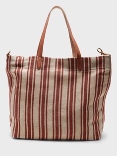 A sturdy canvas tote made to carry the essentials and then some.  Leather handles.  Hanging slip pocket inside.  Fully lined.  Height: 16" (41cm) Width: 13. 4" (34cm) Depth: 4. 75" (12cm) Casual Weekender Tote Bag, Canvas Beach Bag With Handles For Daily Use, Cotton Beach Bag With Double Handle For Everyday Use, Everyday Canvas Bag With Double Rolled Handles, Everyday Use Canvas Bag With Double Rolled Handles, Cotton Double Handle Beach Bag For Everyday Use, Canvas Bags With Rolled Handles For Shopping, Casual Canvas Bag With Rolled Handles For Travel, Casual Canvas Bag With Rolled Handles For Daily Use