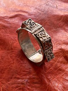 "Presenting a wonderful, vintage silver bracelet, BRACELET from North Africa, most likely Tunisia. The bracelet measures 13/16\" (2,05 cm) wide and its inner diameter is approximately 2 1/4\" (5,65 cm). It is hallmarked for 800 silver near the pin closure. The 3D effect is fantastic, adding amazing texture to the bracelet. It features raised \"spikes\" with \"Arabic\" letters on them along with twisted wire designs. This type of bracelet was made for export." Collectible Sterling Silver Antique Bracelet, Vintage Sterling Silver Bracelets With Intricate Design, Adjustable Antique Sterling Silver Bracelet, Antique Hallmarked Bracelets For Ceremonial Occasions, Heavy Antique Silver Bangle Bracelet, Antique Sterling Silver Bracelets, Vintage Oxidized Antique Silver Bracelet, Vintage Silver Bangle With Jubilee Bracelet, Vintage Antique Silver Bracelets For Festival