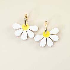 These sweet Daisy charms are so versatile and brighten up any outfit. Choose from marbled white or matte white acrylic, both hand-made in our NYC studio. The charms hang from elegant 14k gold-filled hoops and are removable so you can wear the hoops on their own—two earrings in one! For this design we recommend the 18mm size (as shown in the photos) though the beauty is in being able to switch them up to match your vibe as part of our Hoop Charms system. The hoop options available here are for si Summer Flower Charm Jewelry, Nickel Free Flower Earrings For Summer, Spring Hoop Earrings With Flower Charm As Gift, Spring Flower Charm Hoop Earrings As Gift, Everyday Flower Charm Hoop Earrings, Gold Flower Charm Earrings For Summer, Spring Gift Hoop Earrings With Flower Charm, Feminine Spring Dangle Earrings, Yellow Dainty Jewelry For Summer