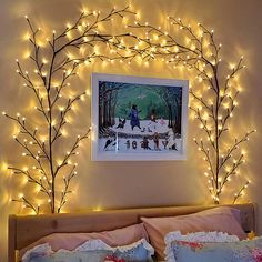 a bedroom with lights on the wall and a teddy bear bed in front of it