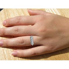 a woman's hand with a diamond ring on it