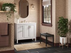 a bathroom with a sink, mirror and toilet in it's corner next to a potted plant