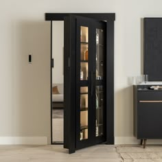 a tall black cabinet with glass doors in a room