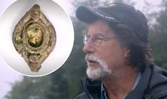 a man wearing glasses and a hat next to a gold ring with an image of a lion on it