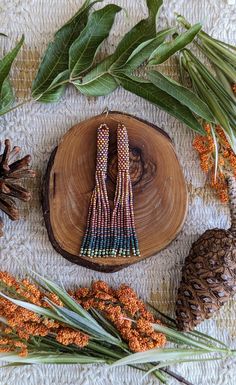 Beautiful tassel earrings in amber orange, copper, green, and gold miyuki and fire polished beads. The amber orange adds the perfect amount of shine for bringing in the new season.  Made with high quality Japanese seed beads. Comes with a gift box 🎁💞 Multicolor Fringe Dangle Jewelry, Festival Fringe Earrings With Round Beads, Orange Bohemian Drop Earrings, Bohemian Orange Tassel Earrings, Orange Bohemian Drop Earrings Jewelry, Artisan Beaded Fringe Earrings For Jewelry Making, Artisan Brown Jewelry With Tassels, Bohemian Orange Tassel Earrings For Festivals, Artisan Jewelry With Beaded Fringe For Crafting