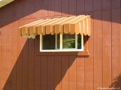 an orange awning on the side of a brown building