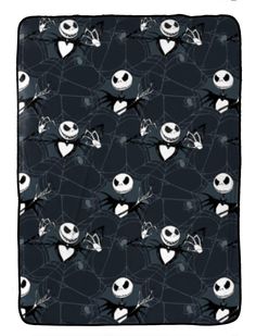 a black blanket with skulls and spider webs on it, in the shape of hearts