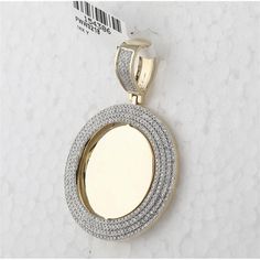 Celebrate the brilliance of refined design with this exquisite 14K Yellow Gold Diamond Circle Picture Memory Pendant. Crafted to honor both timeless beauty and sentimental value, this pendant captures the essence of elegance. The warm hue of 14K yellow gold provides the perfect backdrop for a striking round shape, embodying both simplicity and sophistication. Surrounding the center is a dazzling halo of pave-set diamonds, totaling 1.15 carats, which add a radiant sparkle to the piece. Each diamo Luxury Yellow Gold Oval Pendant Jewelry, Rose Gold Pendant Jewelry With Pave Setting, Luxury Yellow Gold Jewelry With Round Stone, Yellow Gold Plated Jewelry With Pave Setting, Oval White Gold Plated Jewelry, Oval White Gold-plated Jewelry, Luxury Engraved Diamond White Jewelry, Dazzling Gold Round Pendant Necklaces, Dazzling Gold Round Pendant Necklace