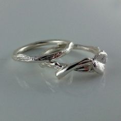 two silver rings sitting on top of a table