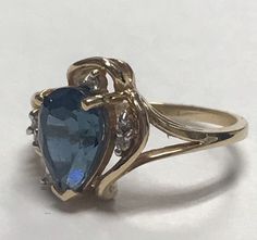 STUNNING 14K Yellow Gold Pear Shape BLUE TOPAZ and DIAMONDS Ring Size 6 It is a size 6 Total weight of 3.7 grams solid 14K gold! Large pear 6mm x 9mm Blue Topaz set into a 14k Yellow Gold setting with (7) seven small round genuine diamonds. It is a beautiful ring and it will look beautiful on any one who wears it! Ships in gift box and insured! Blue Pear-shaped Ring With Accent Stones, Fine Jewelry Blue Pear-shaped Topaz Ring, Yellow Gold Teardrop Sapphire Ring For Anniversary, Teardrop Yellow Gold Sapphire Ring For Anniversary, Fine Blue Topaz Ring Pear-shaped, Teardrop Sapphire Ring In Yellow Gold For Anniversary, Yellow Gold Pear-shaped Ring With Accent Stones, Pear-shaped Blue 14k Gold Ring, Blue Pear-shaped 14k Gold Ring