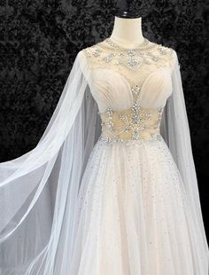 a white wedding dress with long sleeves and beading