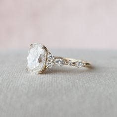 a close up of a diamond ring on a table