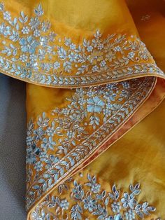 Update! - Zynah covered by LBB - https://lbb.in/bangalore/zynah-designs-handloom-sarees/ This is a precious organza saree in charming yellow color with gotapatti, zardosi, pearl work, and cutwork embroidery, especially for Organza Lovers. The saree features a beautiful floral butis in gotapatti zardosi embroidery work all over the saree. The border is decorated with florals and leaves in gotapatti, zardosi embroidery, adorned with cut-work, and is highlighted with embroidery and pearl work. Colo Mirror Work Design, Saree 2023, Latest Embroidery Blouse Designs, Embroidery Zardozi, Embroidered Suits, Classic Saree, Kurtis Design, Stylish Kurtis, Zardosi Embroidery