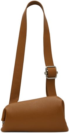 Asymmetrical grained leather shoulder bag in tan. · Adjustable shoulder strap · Silver-tone logo stamp at back face · Hinged closure · Patch pocket at interior · Cotton canvas lining · H6.5 x W11 x D3 Supplier color: Tan brown Modern Brown Saddle Bag Satchel, Modern Leather-lined Saddle Shoulder Bag, Modern Cognac Saddle Bag With Leather Lining, Classic Crossbody Shoulder Bag With Leather Strap, Classic Leather Strap Crossbody Shoulder Bag, Modern Crossbody Shoulder Bag With Leather Strap, Modern Cognac Saddle Bag With Detachable Strap, Modern Flap Bag With Leather Lining, Modern Brown Saddle Bag With Detachable Strap