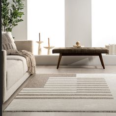 a living room with a couch, coffee table and potted plant