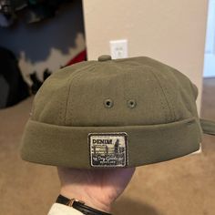 Never Worn Green Brimless Hat. Casual Adjustable Mini Hats For Winter, Casual Brimmed Mini Hat For Winter, Casual Winter Brimmed Mini Hats, Casual Adjustable Brimmed Beanie, Adjustable Casual Flat Cap Beanie, Khaki Flat Cap For Winter, Casual Green Baseball Cap For Winter, Khaki Winter Flat Cap, Casual Beanie For Streetwear