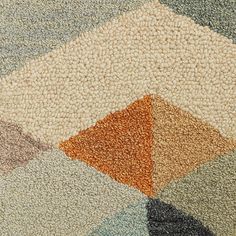 a close up view of a rug with different colors and shapes on it's surface