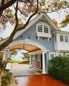 a blue and white house with an arched doorway