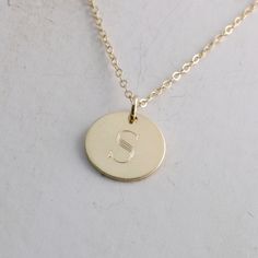 "Solid gold engraved initial necklace is a family heirloom that will be cherished and treasured for many years... it is the PERFECT gift! PICTURE IS ENLARGED TO SHOW DETAIL! SEE SECOND PICTURE FOR SIZE COMPARISON. PLEASE READ BELOW FOR ACTUAL MEASUREMENTS!! Your choice of one, two, or three solid gold 1/2\" (13mm) discs have been personalized just for you with a classy block font in a large 7mm size and it is GORGEOUS! (Font is shown in picture #6 above) The pendants hang from a solid 14k gold 1 Classic Initial Necklace As A Gift, Classic Pendant Initial Necklace As A Gift, Engraved 14k Gold Name Necklace For Anniversary, Classic Necklaces With Initial Pendant For Anniversary, Personalized 14k Gold Initial Necklace For Anniversary, Engraved Gold Name Necklace For Anniversary, Classic Necklaces For Anniversary With Initial Pendant, Classic Engraved Initial Necklace As Gift, Personalized Yellow Gold Necklaces For Anniversary