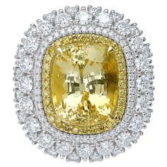 Introducing our exquisite 18K gold ring, featuring a stunning 12.00 carat Unheated Yellow Sapphire, certified by GIA (certificate number 6362682257). This magnificent gemstone is encircled by a dazzling halo of 3.10 carats of meticulously arranged yellow and white diamonds, enhancing its natural brilliance and charm. Weighing approximately 11.9 grams, this piece is crafted with precision and elegance, making it a true masterpiece of luxury and sophistication. The vibrant yellow hue of the sapphire, untouched by heat treatment, is a testament to its natural beauty and rarity. In ancient cultures, Yellow Sapphire was revered for its believed ability to attract prosperity and good fortune. It was often worn by royalty and esteemed individuals, thought to bring wealth, wisdom, and success to i Luxury Yellow Gold Cabochons For Anniversary, Asymmetrical Ring, Yellow Sapphire Rings, Gia Certificate, Rosecut Diamond Ring, Diamond Cocktail Ring, Marquise Ring, Vs2 Diamond, Diamond Cocktail Rings