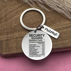 a security guard keychain is shown on top of a wooden table with fur