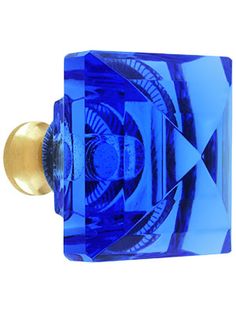 a blue glass cabinet door knob with an abstract design on the front and back side