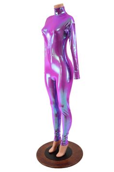 This holographic catsuit is made from our Plumeria four way stretch spandex.  The color shift from deep orchid to icy blue is mesmerizing!  This suit has long sleeves, a turtleneck, and a back zipper.Womens Sizing (See below for instructions on where measurements should be taken)XXS: Bust 29"-30" / Waist 22"-23" / Hips 30"-32"Extra Small: Bust 31"-32" / Waist 24"-25" / Hips 33"-35"Small: Bust 33"-34" / Waist 26"-28" / Hips 36"-37"Medium: Bust 35"-37" /Waist 28"-31" / Hips 38"-40"Large: Bust 39"- Metallic Shiny High Stretch Unitard, Metallic Stretch Unitard For Night Out, Metallic High Stretch Unitard For Party, Metallic Fitted Long Sleeve Bodysuit, Pink Fitted Bodysuit For Winter, Fitted Pink Bodysuit For Winter, Long Sleeve High Stretch Unitard For Parties, Stretch Unitard For Winter Party, Winter Party Stretch Unitard