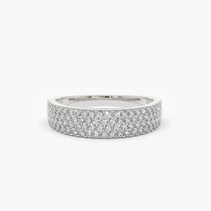 a white gold wedding band with rows of round brilliant cut diamonds on the outside, set in 18k white gold