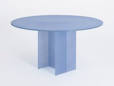 a round blue table sitting on top of a white floor