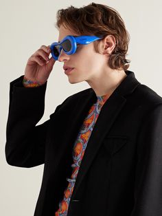 Loewe often experiments with different shapes and proportions, like the inflated acetate frames on these sunglasses. Made in Italy, they have dark-grey lenses and the brand's logo stamped along the arms. Modern Blue Acetate Sunglasses, Inflated Sunglasses, Kong Movie, Hong Kong Movie, Round Eyewear, Summer Sunglasses, Acetate Sunglasses, Loungewear Shorts, Fine Jewelry Designers