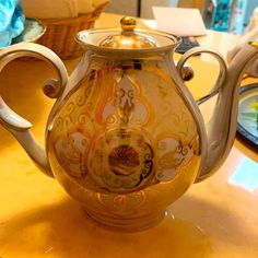 an ornate tea pot is sitting on a table