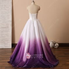 a purple and white wedding dress on display