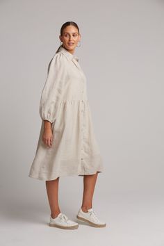 STYLE DETAILS: Shirt dresses are one of those nostalgic trends that always seem to make a comeback. The Studio Midi Shirt Dress is the perfect piece for everyday wear, made from luxurious linen. It features a button-down front and long balloon sleeves for a relaxed yet stylish look. The inside placket is lined with a contrast ribbon, adding extra detail. Pair it with sneakers or boots to suit your occasion. FEATURES: Collar Button-down Balloon sleeves Gathered waist Midi length 100% Linen Lining Chic Collared Linen Dress For Daywear, Spring Daywear Mid-length Linen Dress, Spring Mid-length Linen Dress For Daywear, Knee-length Linen Shirt Dress For Day Out, Collared Linen Midi Dress For Day Out, Chic Linen Shirt Dress With Buttons, Classic Linen Shirt Dress For Day Out, Collared Linen Midi Dress For Work, Spring Collared Linen Dress With Relaxed Fit