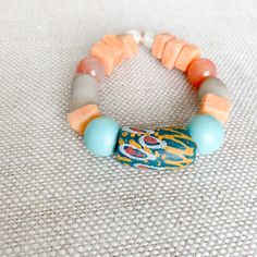 Amalfi Bracelet - BelleStyle Artisan Turquoise Beaded Bangle Bracelet, Artisan Turquoise Beaded Bangle Bracelets, Turquoise Beaded Bracelets With Wooden Beads, Bohemian Bracelet With Round Wooden Beads, Artisan Jewelry With Large Recycled Glass Beads, Bohemian Orange Bangle Jewelry, Orange Bohemian Bangle Jewelry, Unique Turquoise Beaded Bangle Bracelet, Bohemian Orange Stretch Bracelet With Round Beads