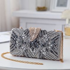 Add a touch of elegance to your evening party look with our exquisite Bridal Clutch Elegant Leaf Locker. This stunning clutch features a unique new design with intricate leaf patterns in a beautiful shade of blue, making it the perfect accessory for any bridal or special occasion outfit. Embellished Clutch For Wedding Guests, Elegant Embellished Evening Bag For Party Season, Festive Silver Party Bag, Festive Silver Party Bags, Elegant Rectangular Evening Bag With Sequins, Silver Sequined Wedding Clutch, Festive Evening Clutch With Sequins, Glamorous Wedding Clutch For Party Season, Silver Festive Evening Bag