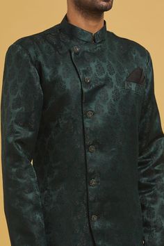 Green sherwani with all over woven paisley pattern. Comes with churidar.
Components: 2
Pattern: Woven
Type Of Work: Paisley
Neckline: Mandarin Collar
Sleeve Type: Full
Fabric: Sherwani: Imp. Soft Jacquard, Churidar: Silk Dupion
Color: Green
Other Details: 
Closure:
Sherwani: Button
Churidar: Drawstring
Note: Pocket square worn by model is not for sale
Occasion: Mehendi and Puja,Sangeet - Aza Fashions Green Formal Traditional Wear With Naqshi Embroidery, Green Naqshi Traditional Wear For Formal Occasions, Formal Green Traditional Wear With Naqshi Detailing, Formal Green Traditional Wear With Naqshi, Elegant Sherwani With Zari Weaving For Festive Occasions, Elegant Eid Sherwani With Zari Weaving, Festive Green Semi-formal Bandhgala, Festive Nehru Jacket With Pallu For Semi-formal Occasions, Semi-formal Traditional Bandhgala With Zari Work