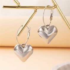 You'll love these heart earrings that will add a sweet touch to any ensemble. 1.06" W x 2.36" L Silver-plated copper Silver Dangle Hoop Earrings For Valentine's Day, Trendy Hoop Jewelry For Valentine's Day, Valentine's Day Hoop Jewelry In Metal, Trendy Valentine's Day Hoop Jewelry, Valentine's Day Hoop Metal Jewelry, Valentine's Day Metal Hoop Jewelry, Trendy Nickel-free Metal Heart Earrings, Heart Shaped Metal Earrings For Valentine's Day, Heart-shaped Metal Earrings For Valentine's Day