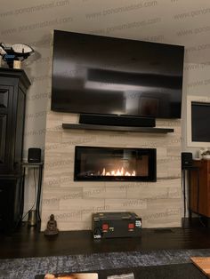 a living room with a fireplace and television mounted on the wall, in front of a flat screen tv